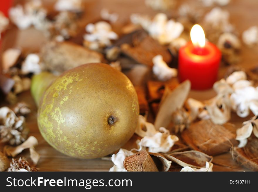 Pear, dried plants and burning candle. Pear, dried plants and burning candle