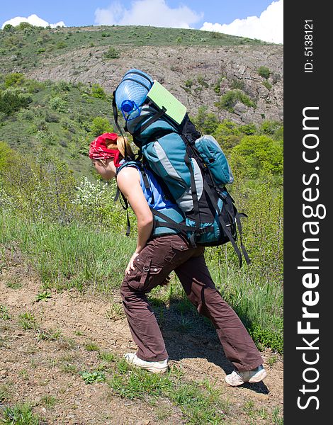 Girl with backpack hiking in mountains. Girl with backpack hiking in mountains