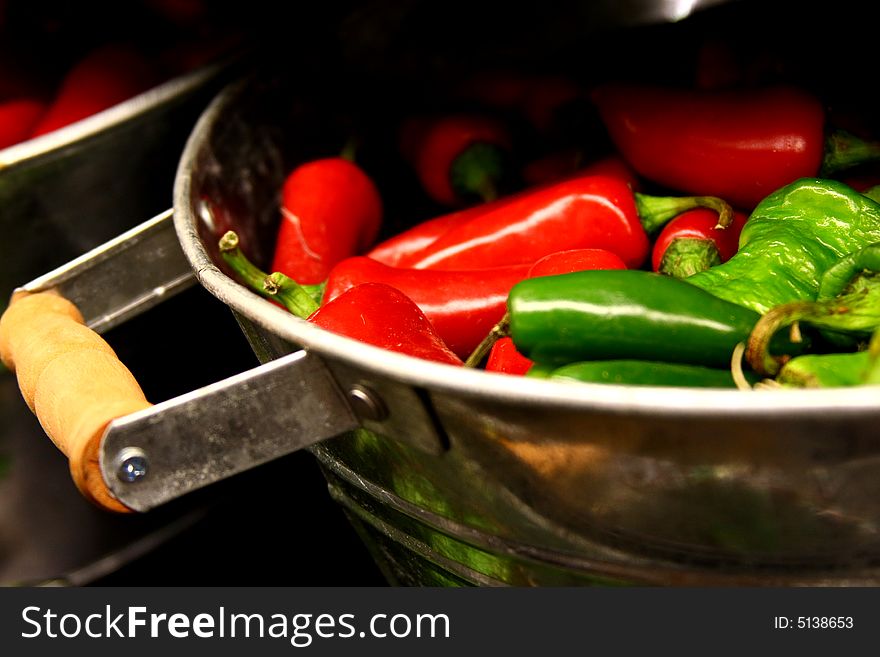 Chili peppers in a bucket for sale in a food store.