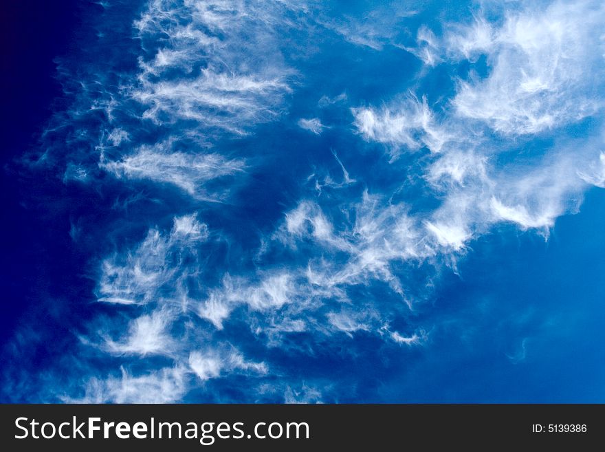 Plumose clouds in the dark blue sky