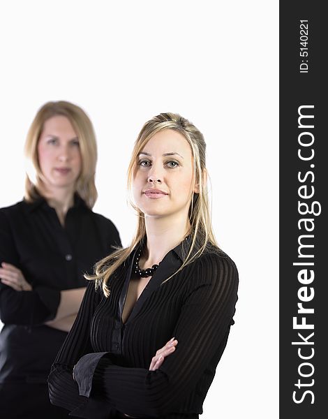 Two blonde business women with arms crossed looking straight ahead. Two blonde business women with arms crossed looking straight ahead