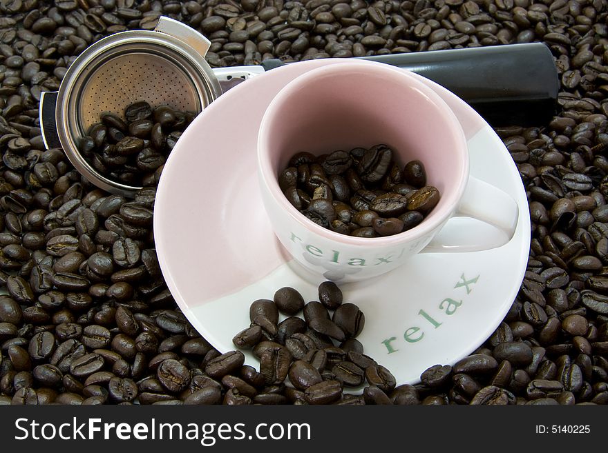 Coffee beans with cup and saucer