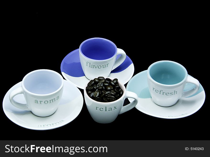 Cups and saucers with fresh roasted coffee beans. Cups and saucers with fresh roasted coffee beans