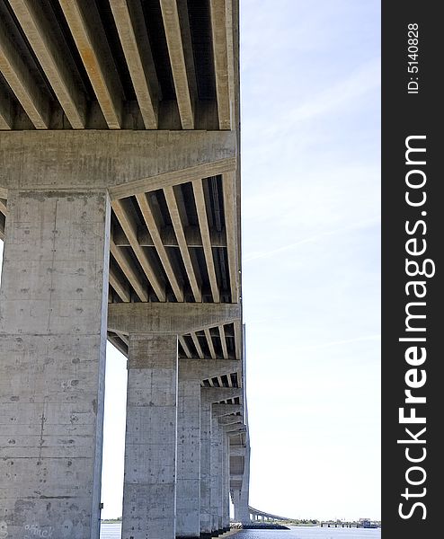 A span of concrete bridge on pillars shot from below. A span of concrete bridge on pillars shot from below