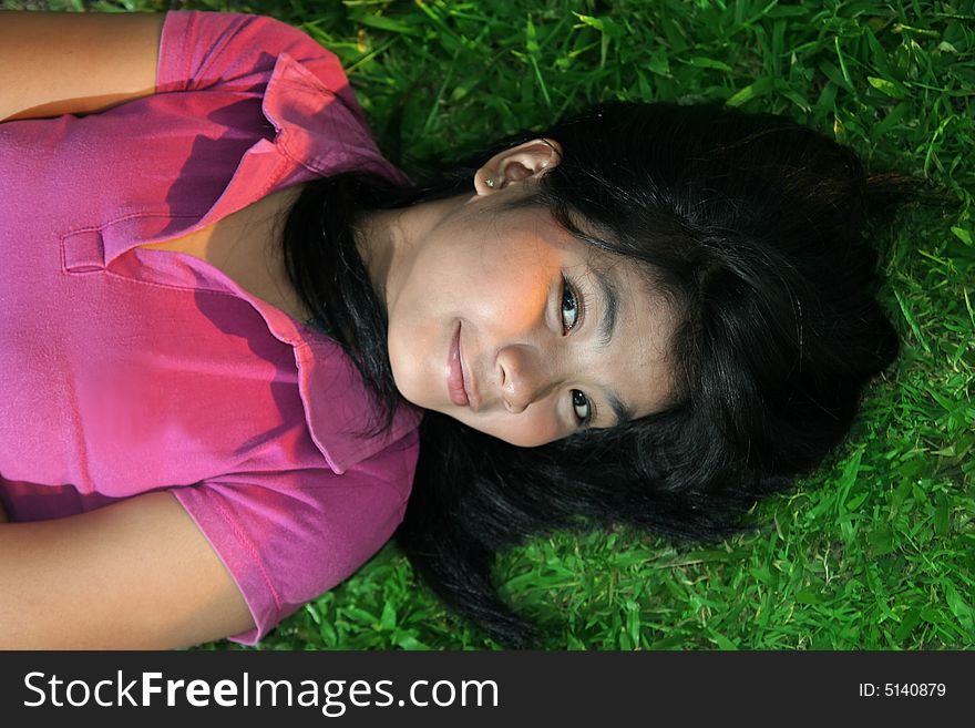 Asian girl lie down on the grass