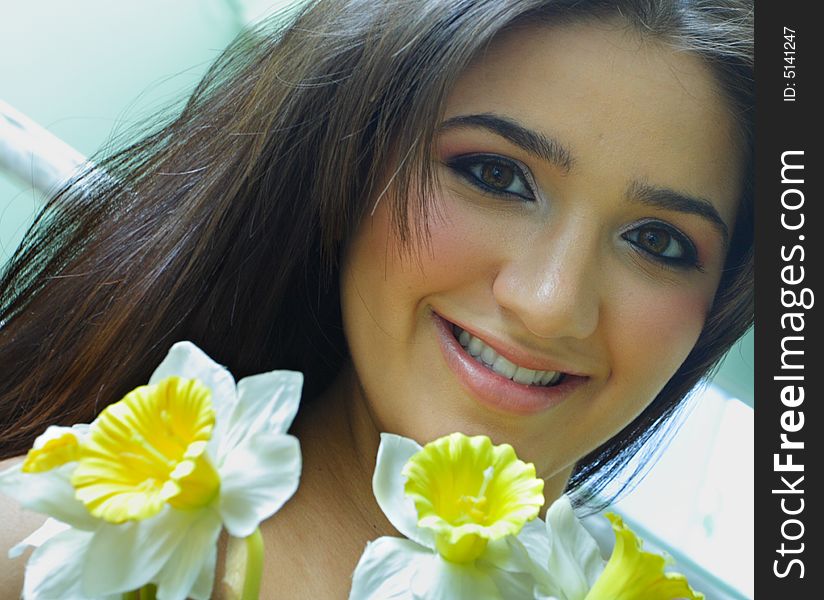 Headshot of a young woman with yellow flowers. Headshot of a young woman with yellow flowers.