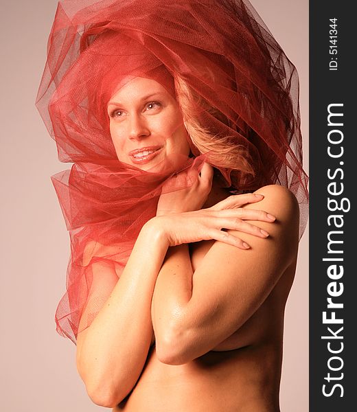 Beautiful Laughing Woman draped in Red Tulle. Beautiful Laughing Woman draped in Red Tulle