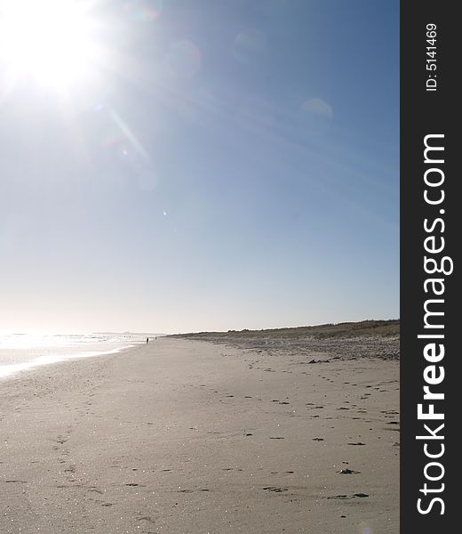 Almost empty beach drenched in bright sunlight. Almost empty beach drenched in bright sunlight.