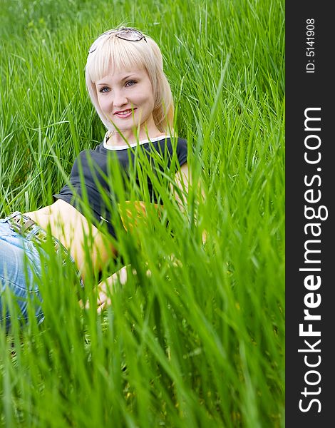 Young girl rest in the green meadow. Young girl rest in the green meadow