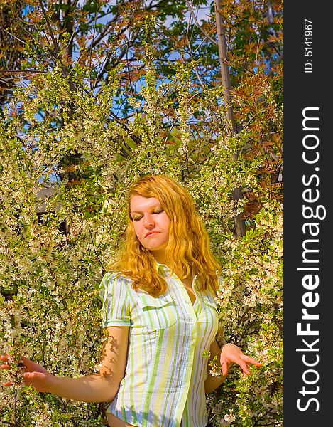 Girl posing near yellow flowers tree. Girl posing near yellow flowers tree