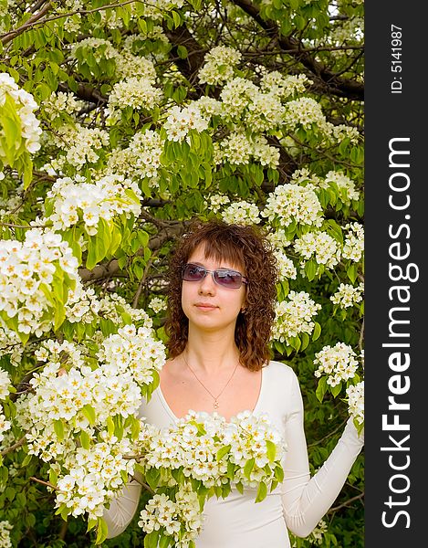 Smiling girl with white flowers tree