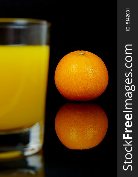 Orange juice isolated against a black background