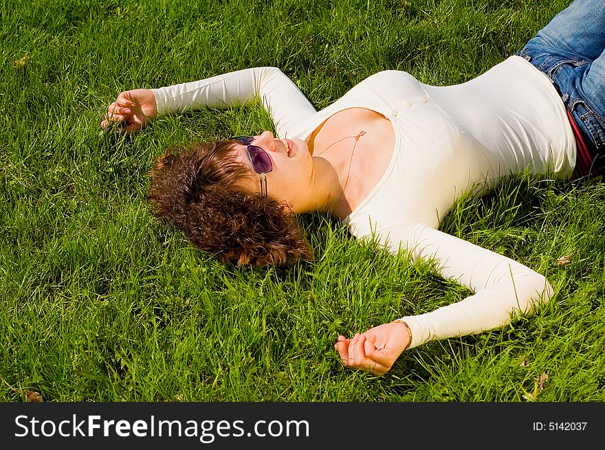 Girl Is Relaxing On The Grass