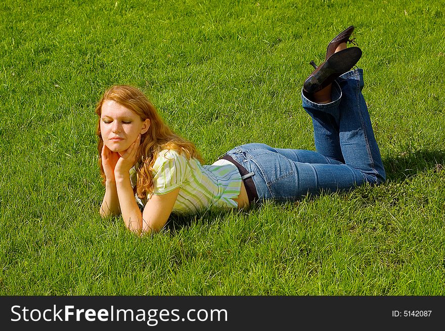 Girl is relaxing on the grass