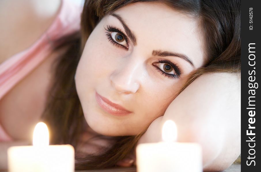 An image of a woman with two candles