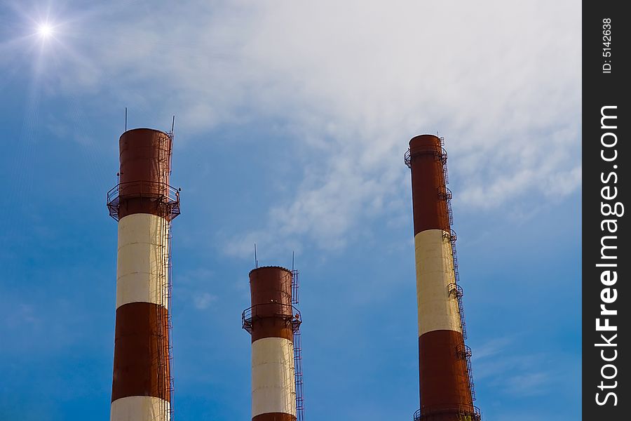 Three factory pipe at blue sky background