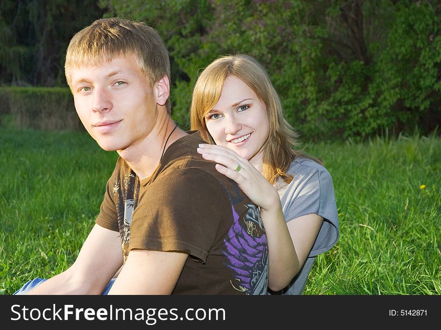 Pretty young couple outdoors, focus on girl