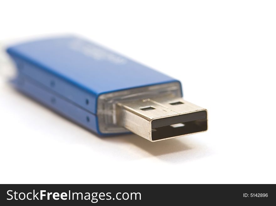 An usb-stick for the computer on a white surface. An usb-stick for the computer on a white surface