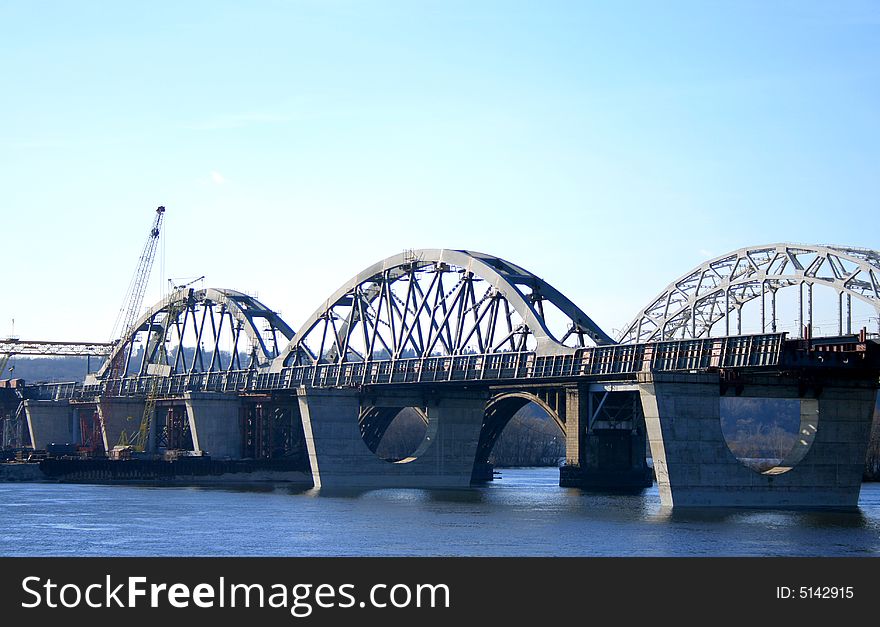 Railway bridges in the southern part of Kiev, Ukraine. Photo taken from the left bank of the Dnieper river. Railway bridges in the southern part of Kiev, Ukraine. Photo taken from the left bank of the Dnieper river.