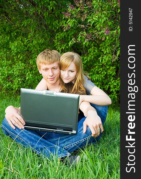 Young couple with laptop outdoors. Young couple with laptop outdoors