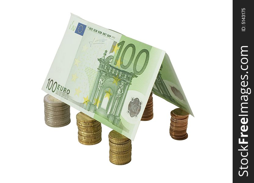 Closeup of a gable roof made from hundred Euro banknotes over coin pillars, isolated on white.  Clipping path saved.