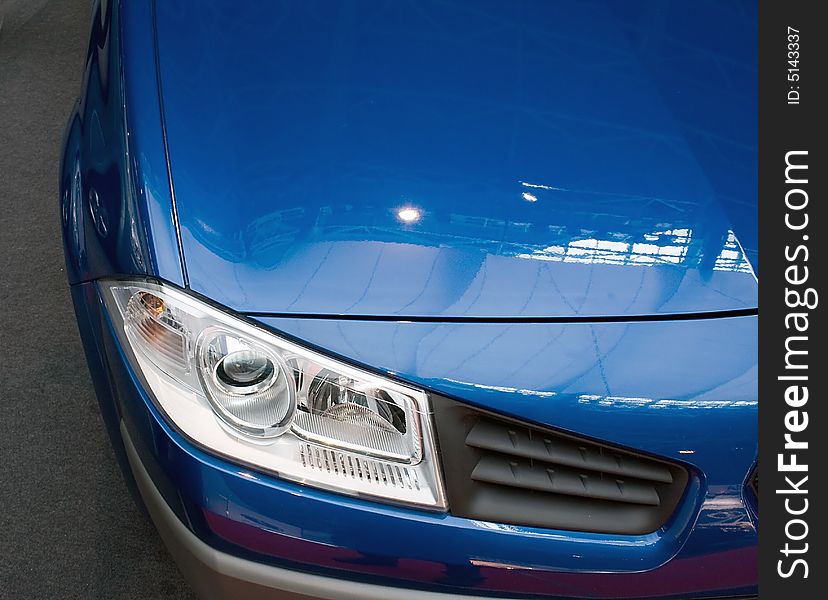 Modern blue car (front view) on the flor. Modern blue car (front view) on the flor