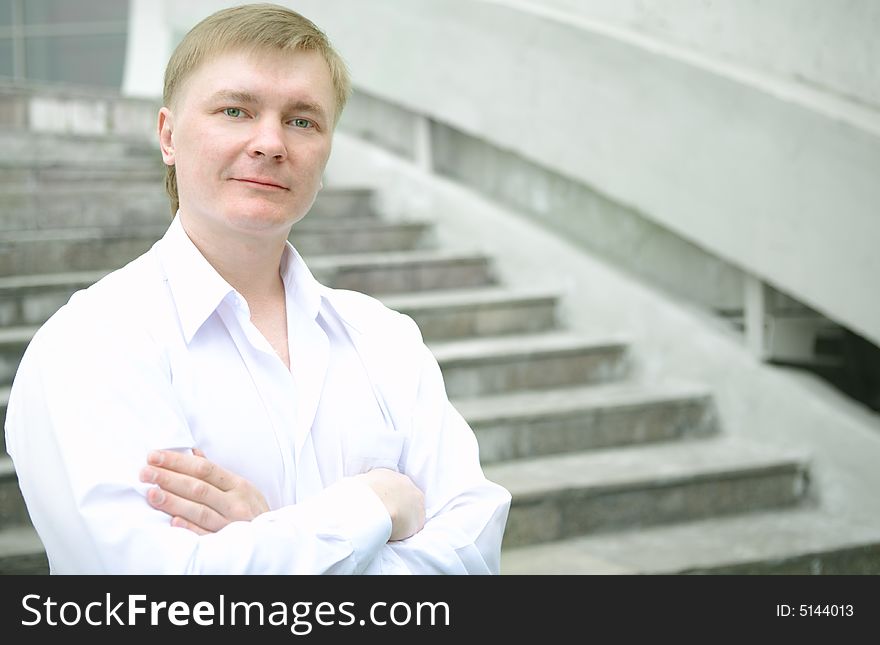 Cheerful young businessman on stairs