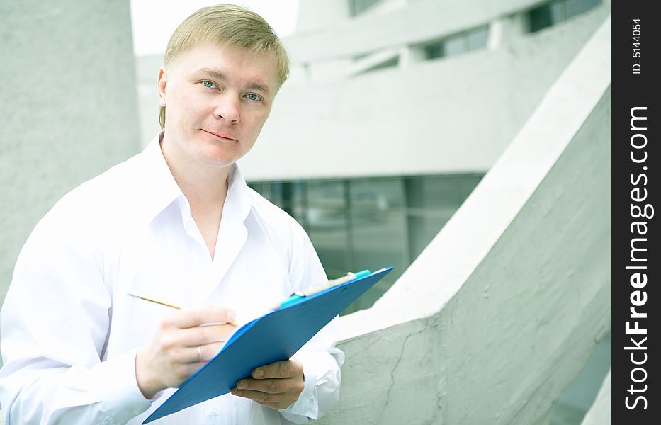 Cheerful young businessman on stairs