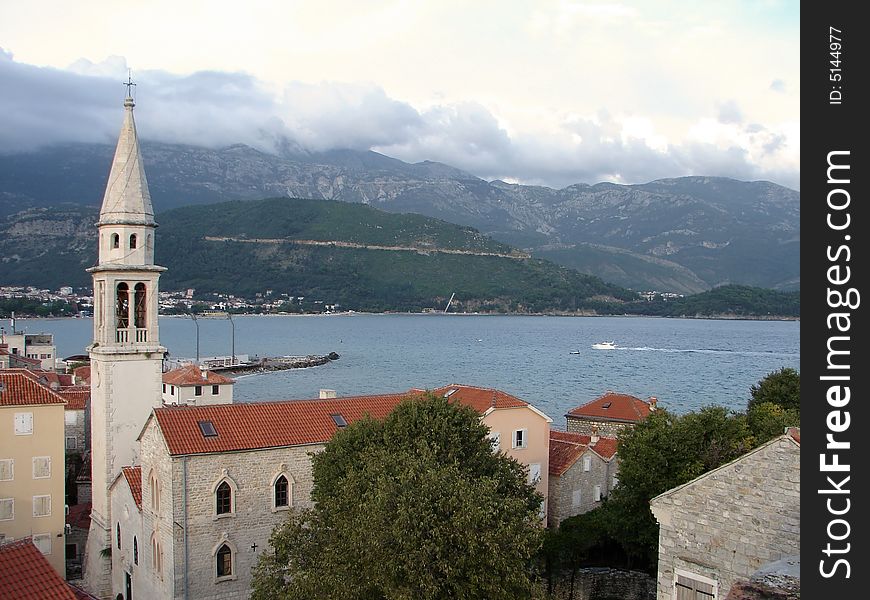 Old city in Montenegro on a background of a sea gulf and mountains. Old city in Montenegro on a background of a sea gulf and mountains