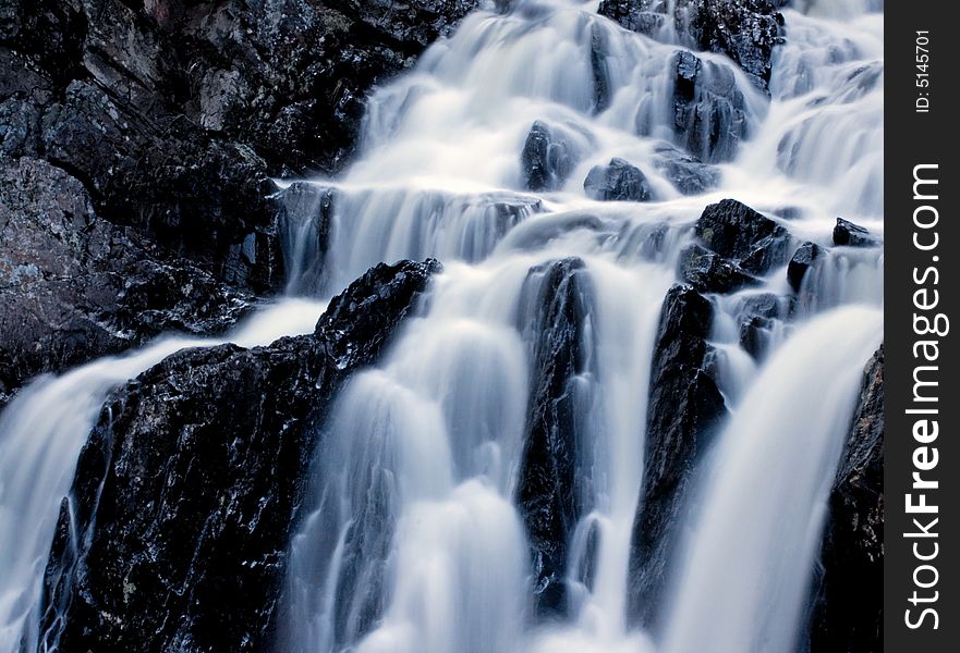 Fast flowing waterfall over jagged rocks