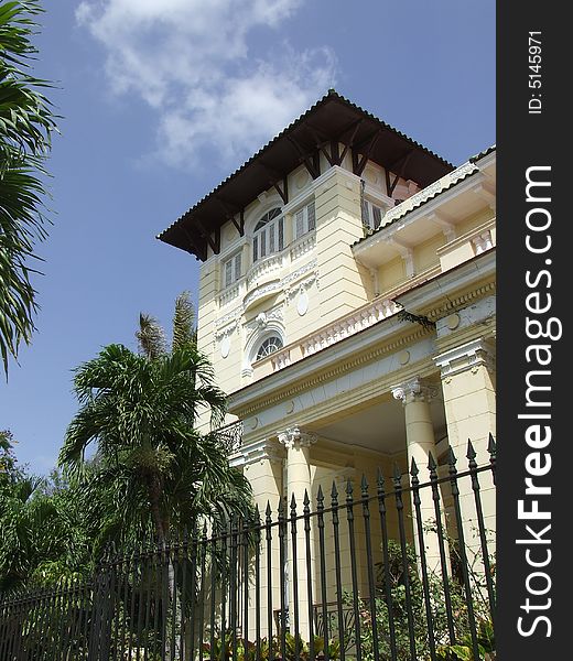 Yellow beautiful building behind a fence, in Havana Cuba. Yellow beautiful building behind a fence, in Havana Cuba