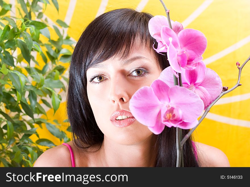 Beautiful asian girl with orchid. Low DOF, focus on eyes