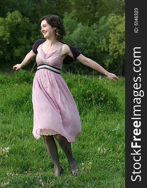 Woman jumping with joy on a green field. Woman jumping with joy on a green field