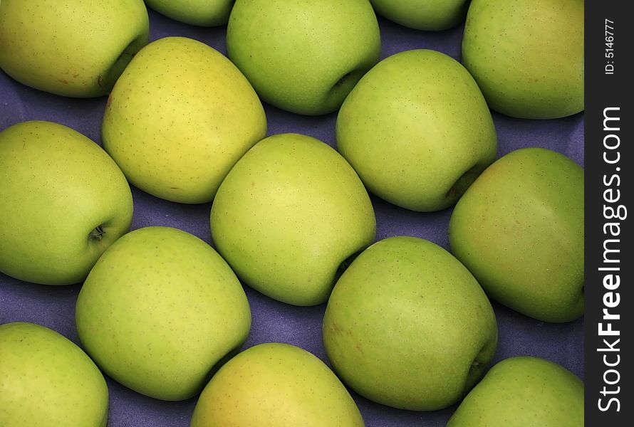 Green apples on a blue background