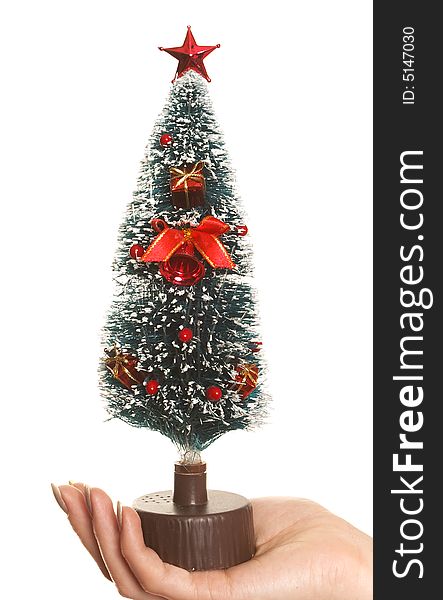 Hand holding Christmas tree isolated over white