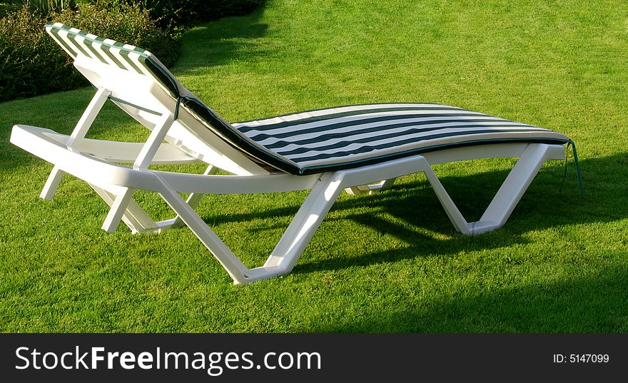 Stove-bench in a green garden on a grass