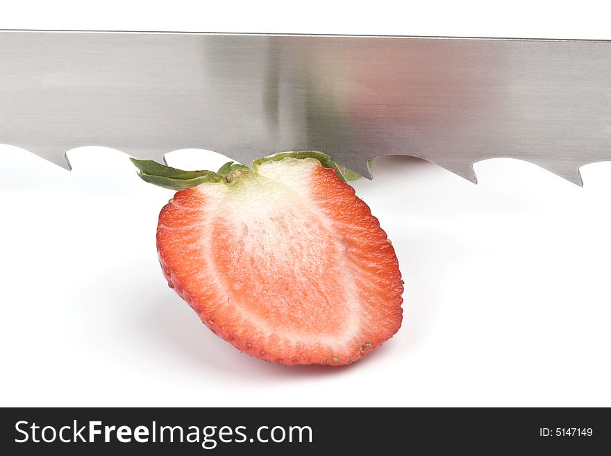 Strawberry and saw-blade on a white