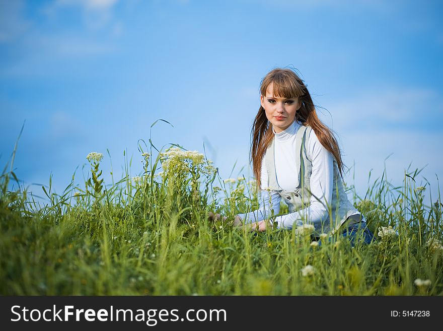 Woman Sitting Among Spring Flowers