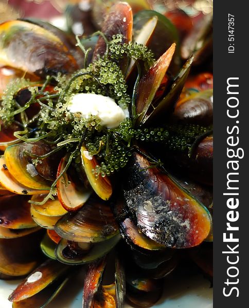 Baked mussel topped with sea weeds and mayo