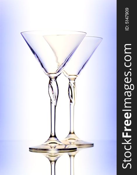 Two glasses for martini on gradient background