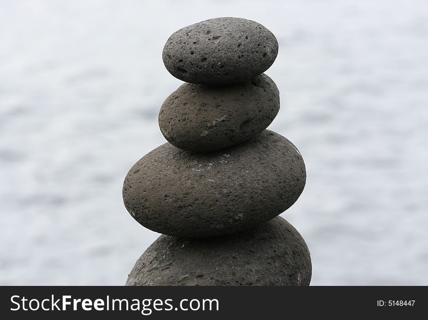 Balanced Stones on top of each other on ocean blue background