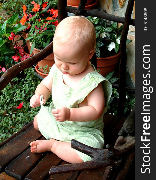 Baby boy on rocking chair on front porch of family home. Baby boy on rocking chair on front porch of family home