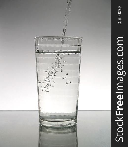 Pouring water in a glass. Pouring water in a glass