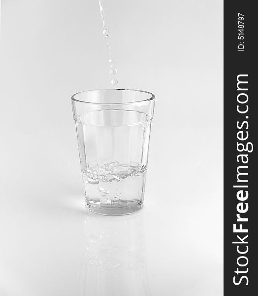 Pouring water in a glass. Pouring water in a glass