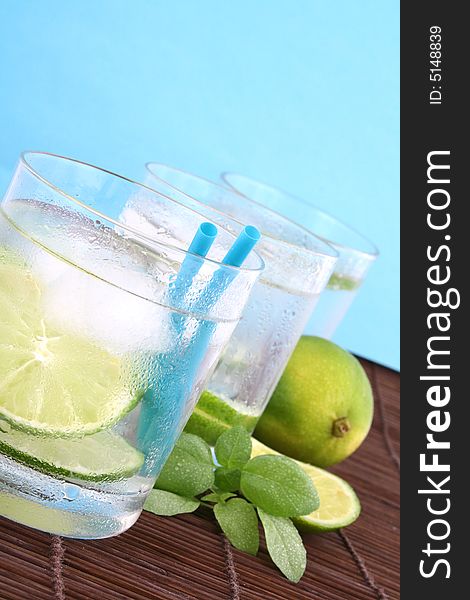 Frosty cold glass of ice water with lime