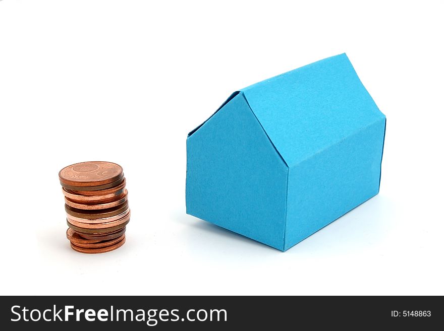 A blue paper house with some coins. A blue paper house with some coins