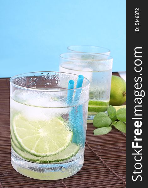 Frosty cold glass of ice water with lime