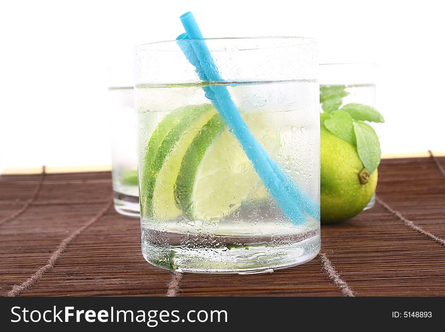 Frosty cold glass of ice water with lime