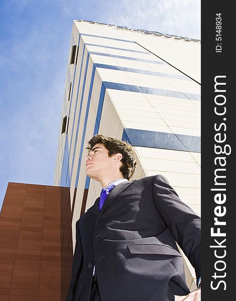 Young businessman portrait against urban background