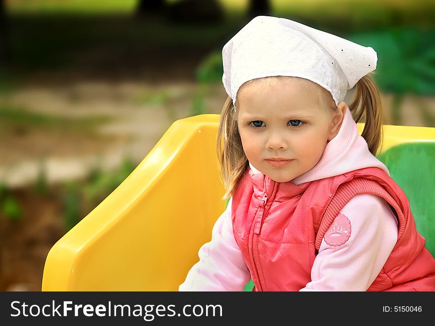 Little girl walks in park